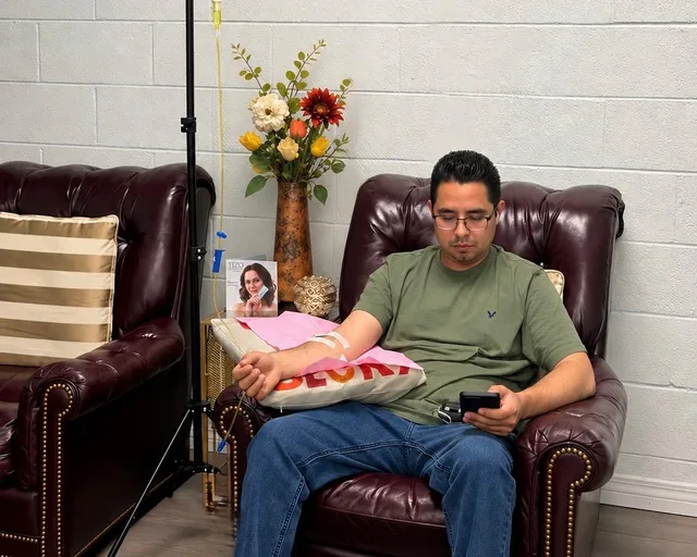 A Revive client relaxing in a recliner during his IV drip